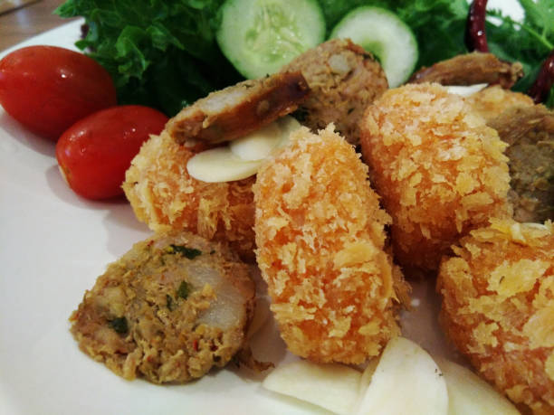 istock Notrhern Thai Spicy Sausage (Sai Aua) with Fried chicken snack and vegetables on white dish. 1247754690