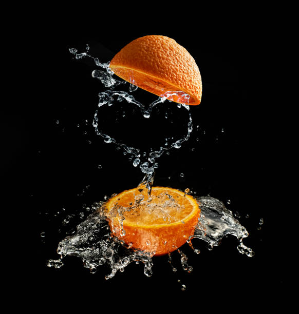 istock A heart shaped splash of water between oranges. 1247754728