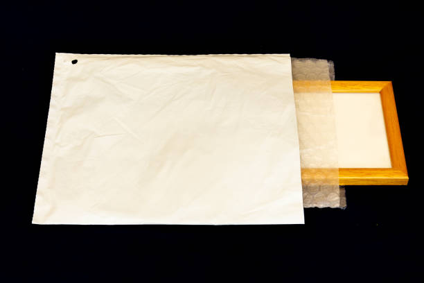 istock Padded envelope with fragile items being prepared for mailing 1247755719