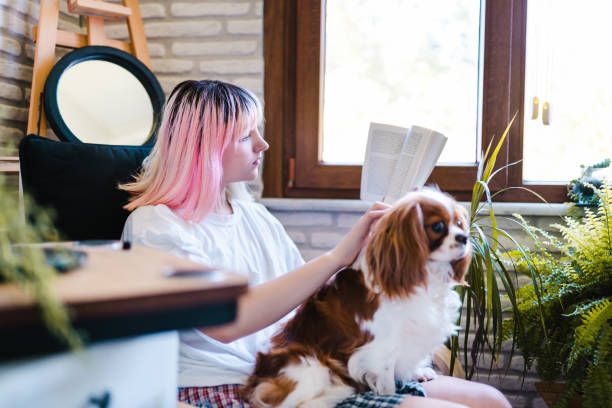 istock Analog Book Reader Millennial woman taking a break from technology with her dog 1247756355