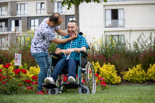 istock Handicapped boy spending time with his father in a wheelchair 1247770062