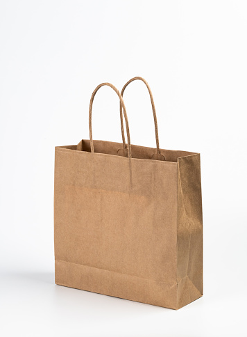 Kraft paper shopping bag on white background