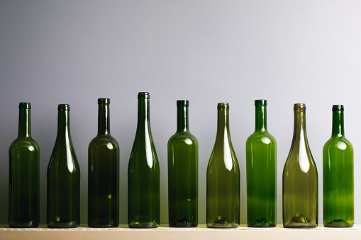 empty wine bottles, gray background with copy-space