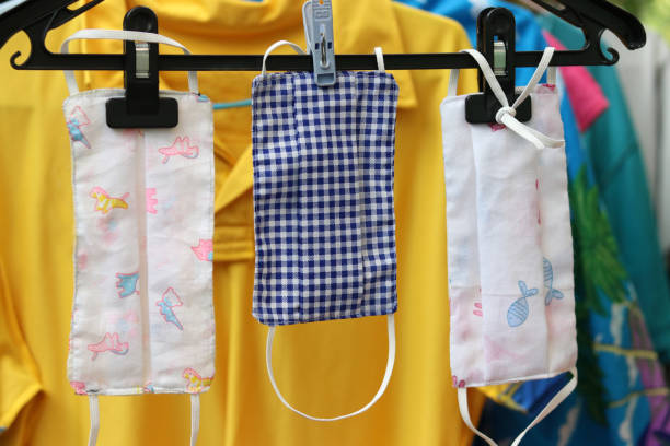 istock DIY handmade protective fabric masks in Thailand hanging on clothes-hanger. 1247773412