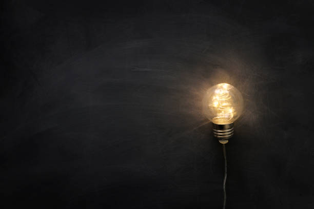istock Education concept image. Creative idea and innovation. Light bulb as metaphor over blackboard 1247783414