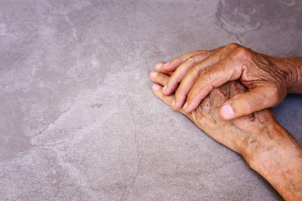 istock close up image of senior male hands over table 1247783434