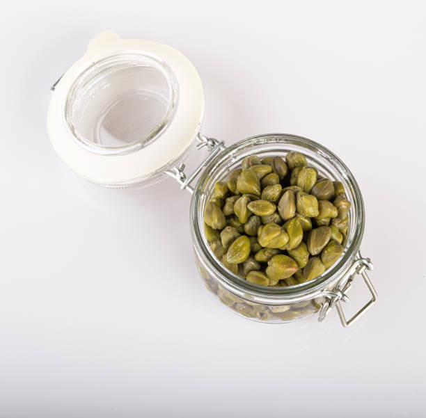 istock capers in a transparent jar, isolated on a white background 1247786888
