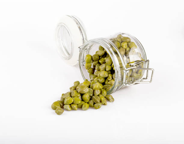 istock capers in a transparent jar, isolated on a white background 1247786976