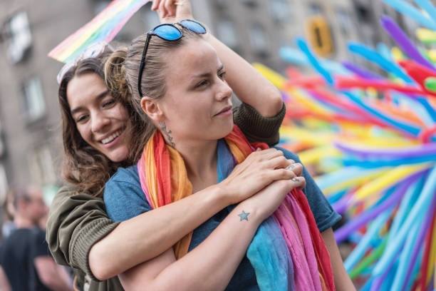 istock Happy couple having fun at the pride parade 1247798845