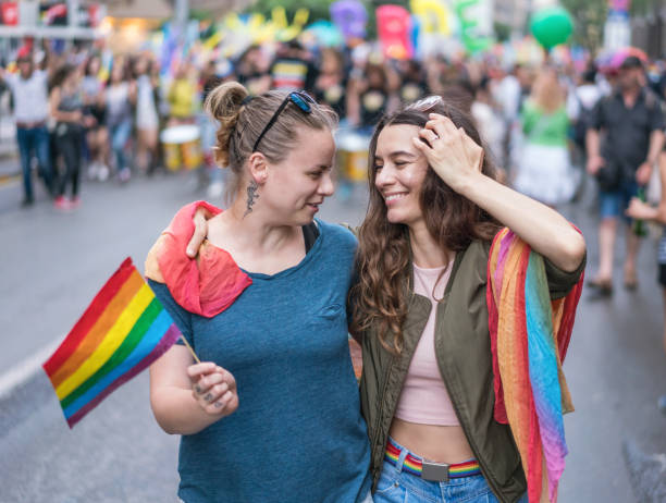 istock Young couple walking with the love parade 1247798848