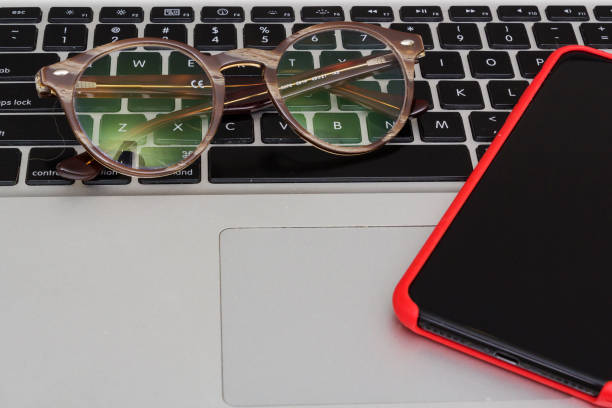 istock work station at home, a phone and glasses 1247799513