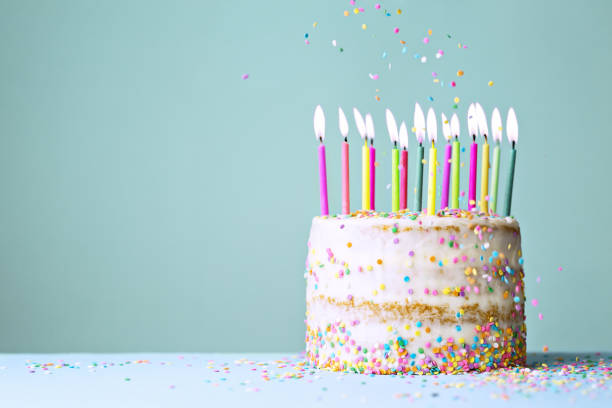 istock Naked funfetti birthday cake with candles 1247804344