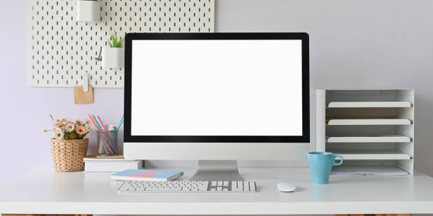 istock Computer monitor is putting on a white working desk surrounded by office equipment. 1247808164