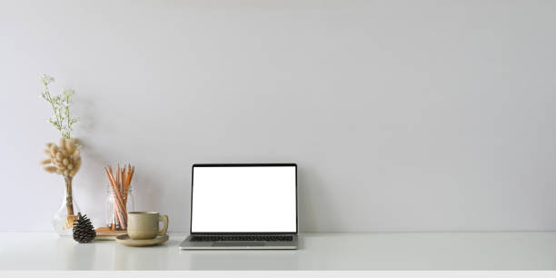 istock Comfortable workspace is surrounding by a white blank screen computer laptop and accessories. 1247808186