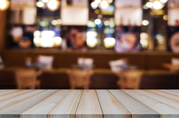 istock wooden table with abstract blurred background resturant lights used for display montage products mock up design. 1247809585