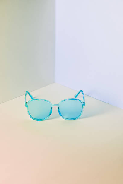 istock Stylish blue sunglasses on modern minimal pastel background, front view. Nobody. Product photograph 1247810596