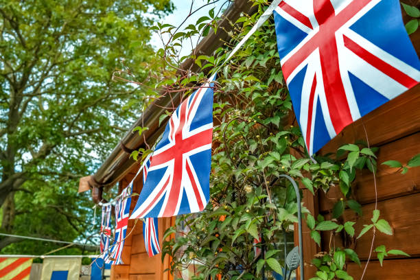 istock Union Jack bunting hanging on the front of a log cabin 1247810604