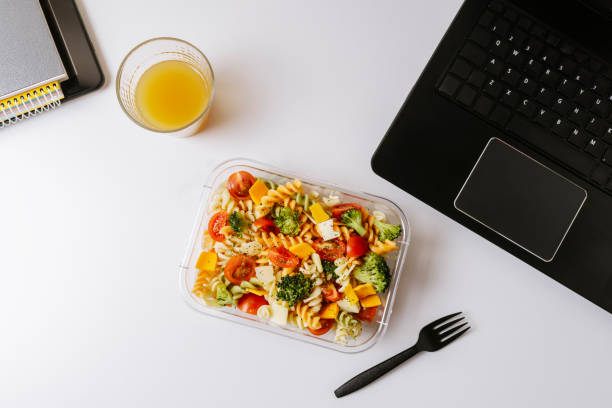 istock Healthy food in lunch box, on working table with laptop 1247810612