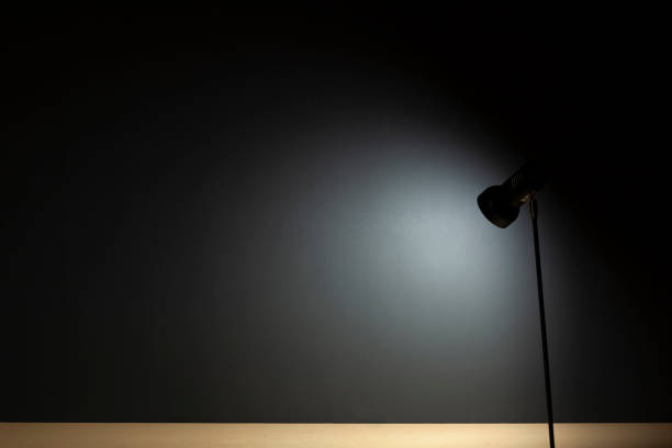 istock Background with lamps on a desk and a black wall 1247811978