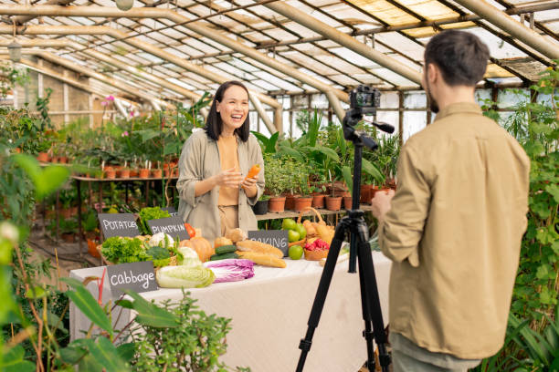 istock Excited Asian girl laughing while making video with colleague 1247828277