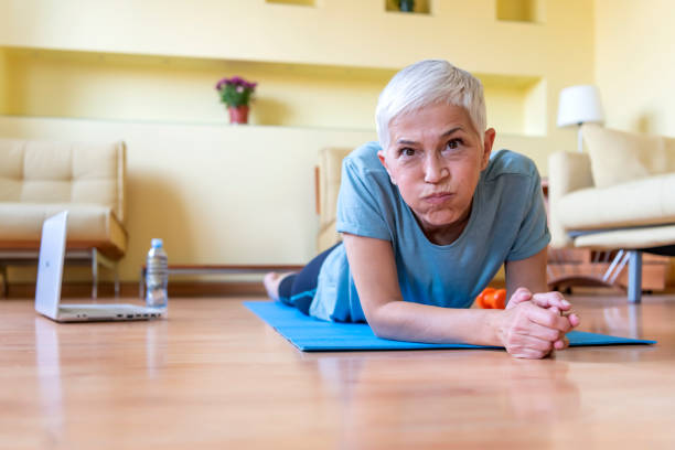 istock Mature Woman Exercise At Home - Quarantine 1247829456