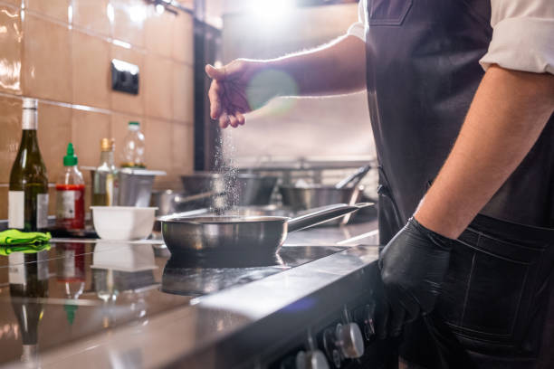 istock Salting food in pan 1247829692