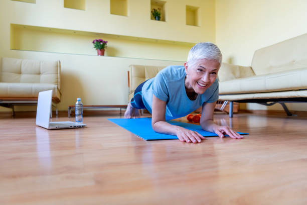 istock Mature Woman Exercise At Home - Quarantine 1247830315