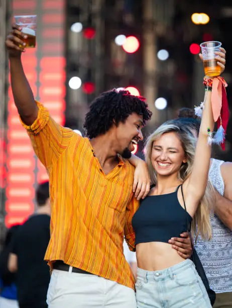 Photo of Young and cheerful couple in music festival.