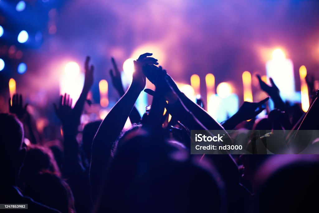 Cheering crowd with hands in air at music festival Happy cheering crowd with hands in air at music festival Party - Social Event Stock Photo