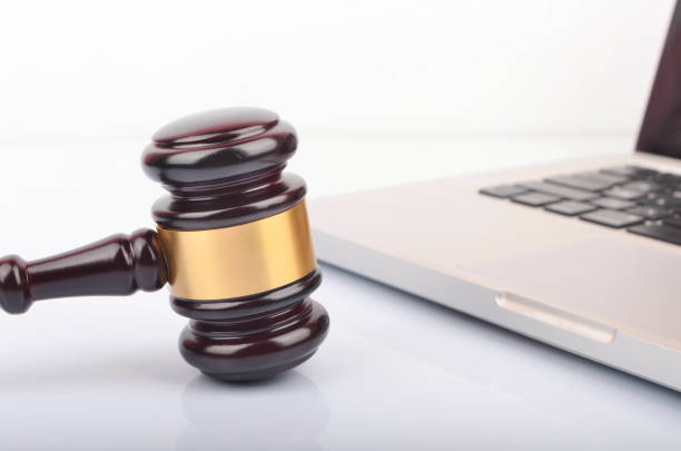 istock cyber crime concept. Gavel on laptop 1247859453