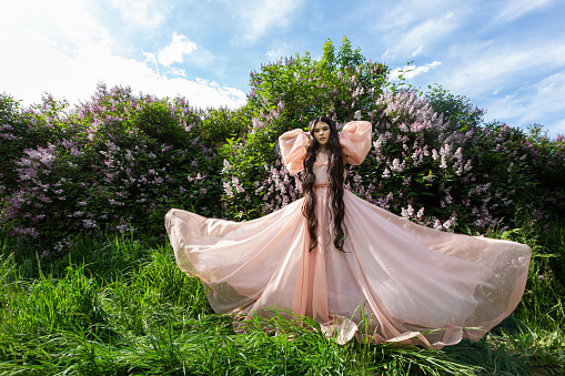 Girl portrait with long hair in a lilac