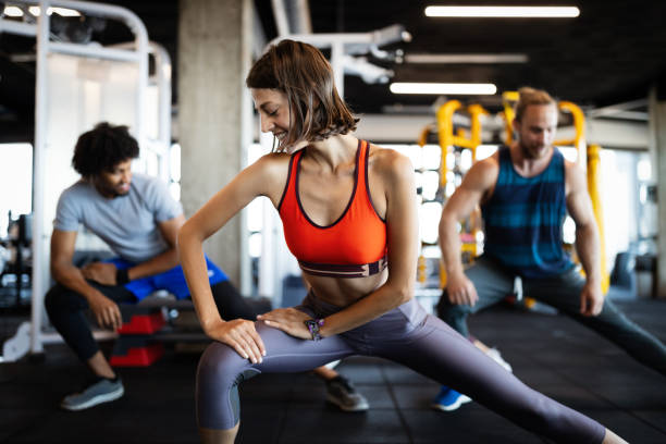istock Group of young people doing exercises in gym 1247864008