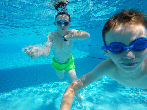 istock Child boy swimming pool water playing summer vacation fun 1247865274