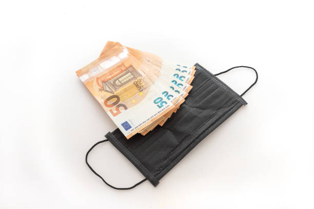 istock Covid-19 masks and money 1247873690