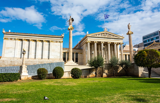 Front facade of the Academy of Athens in Greece, with figures of Athena and Apollo with lyre on the  flanking pillars.