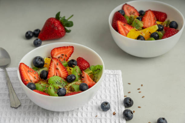istock Two bowls full of mixed fruit and berry salad 1247876376