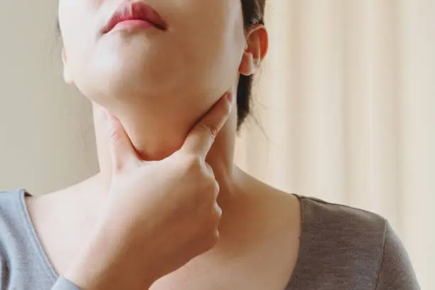 Photo of Women with thyroid gland test . Endocrinology, hormones and treatment. Inflammation of the sore throat