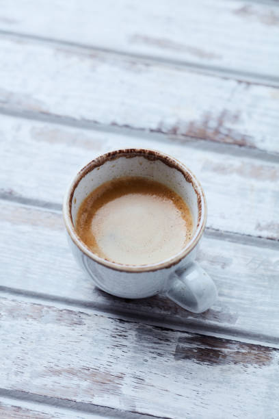 istock Cup of coffee on bright wooden background. 1247882727