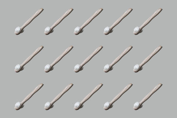 istock Colourful pattern of toothbrushes on grey background. View from top. 1247882771