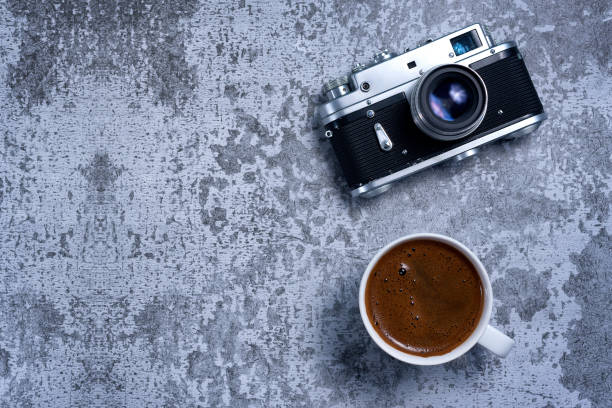 istock Vintage Travel camera and coffee cup on an old rustic table 1247884019
