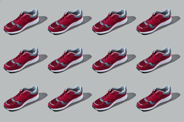 istock Colourful pattern of sneakers on grey background. View from top. 1247884080