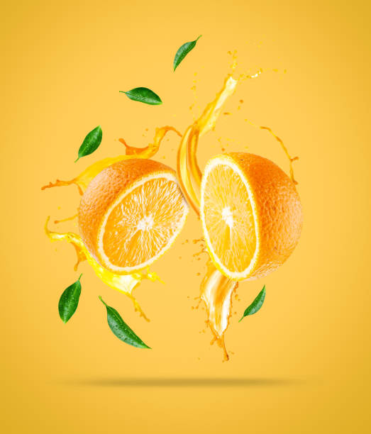 istock Juice splashes out from sliced orange 1247899926