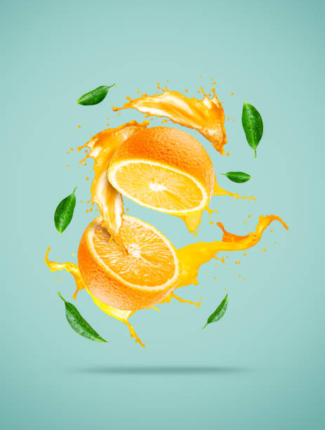 istock Orange slice and juice splash with green leaves 1247899974