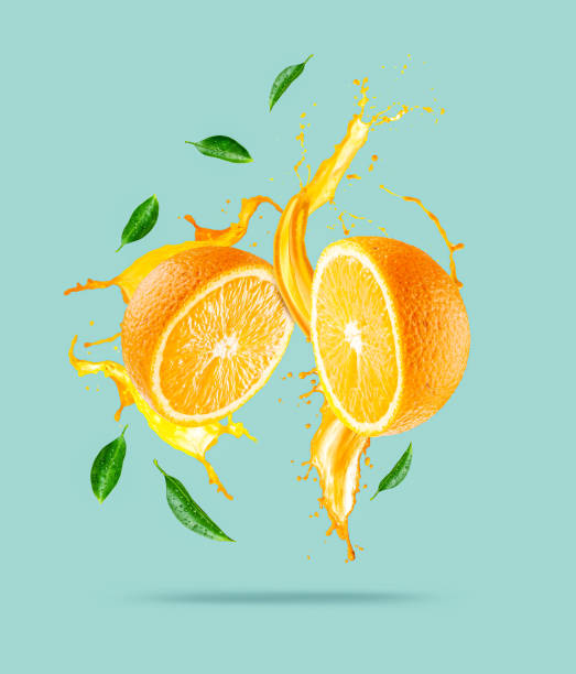 istock Juice splashes out from sliced orange 1247900001