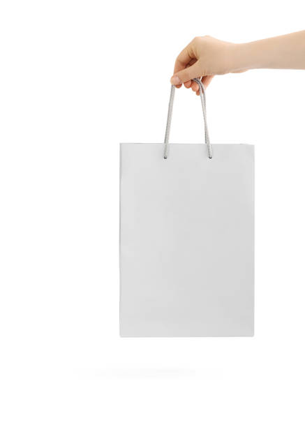 istock Light grey paper bag for shopping in hand. 1247902435