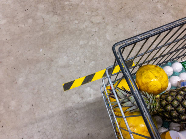 waitng in the line with shppong cart at the supermarket. respect the distance line - 4721 imagens e fotografias de stock