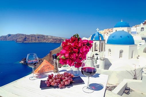 Two glasses of red wine on the background of the sea and Greece