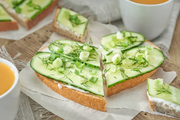 istock Two sandwiches heart shaped with cream cheese, cucumber and green onion. 1247926024