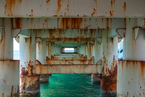 View of sea under the old pier, under the old concrete bridge.