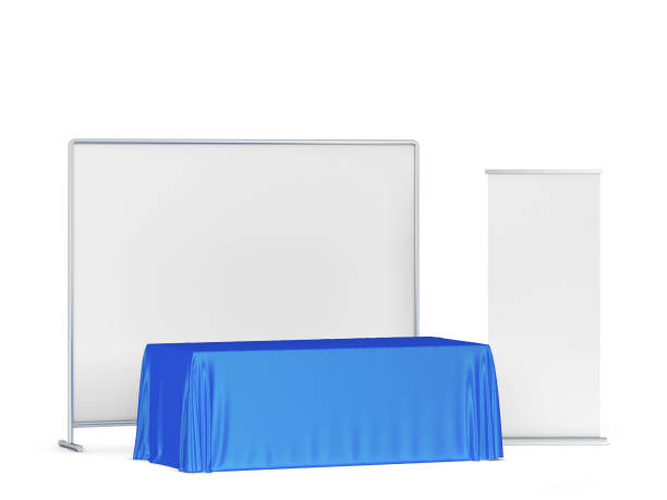istock Blank tradeshow tablecloth with roll-up banners aside 1247940257